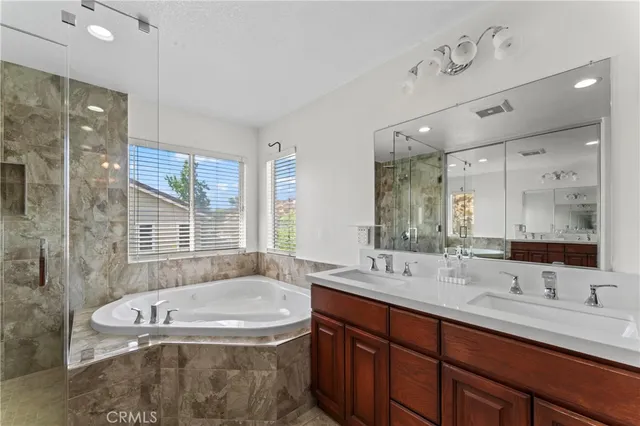 a bathroom with a tub sink double and mirror