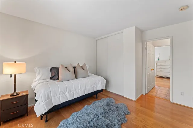 a bedroom with a bed and wooden floor