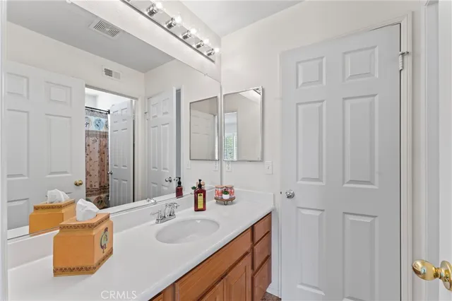 a bathroom with 2 sink tub and a mirror