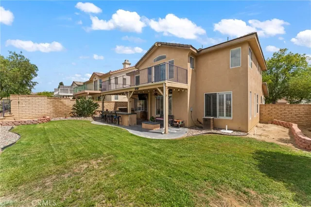 a view of a house with a yard and sitting area