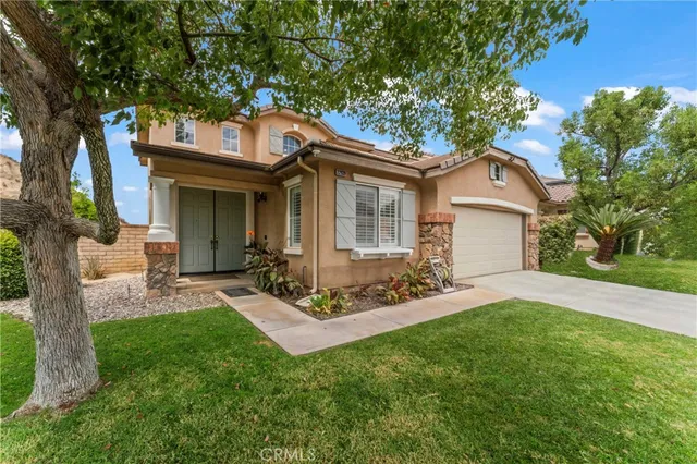 a view of a backyard with table and chairs and a large tree