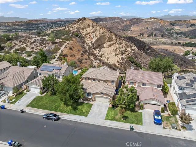 an aerial view of residential houses with outdoor space and street view