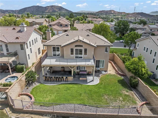 an aerial view of a house with garden space seating area and mountain view