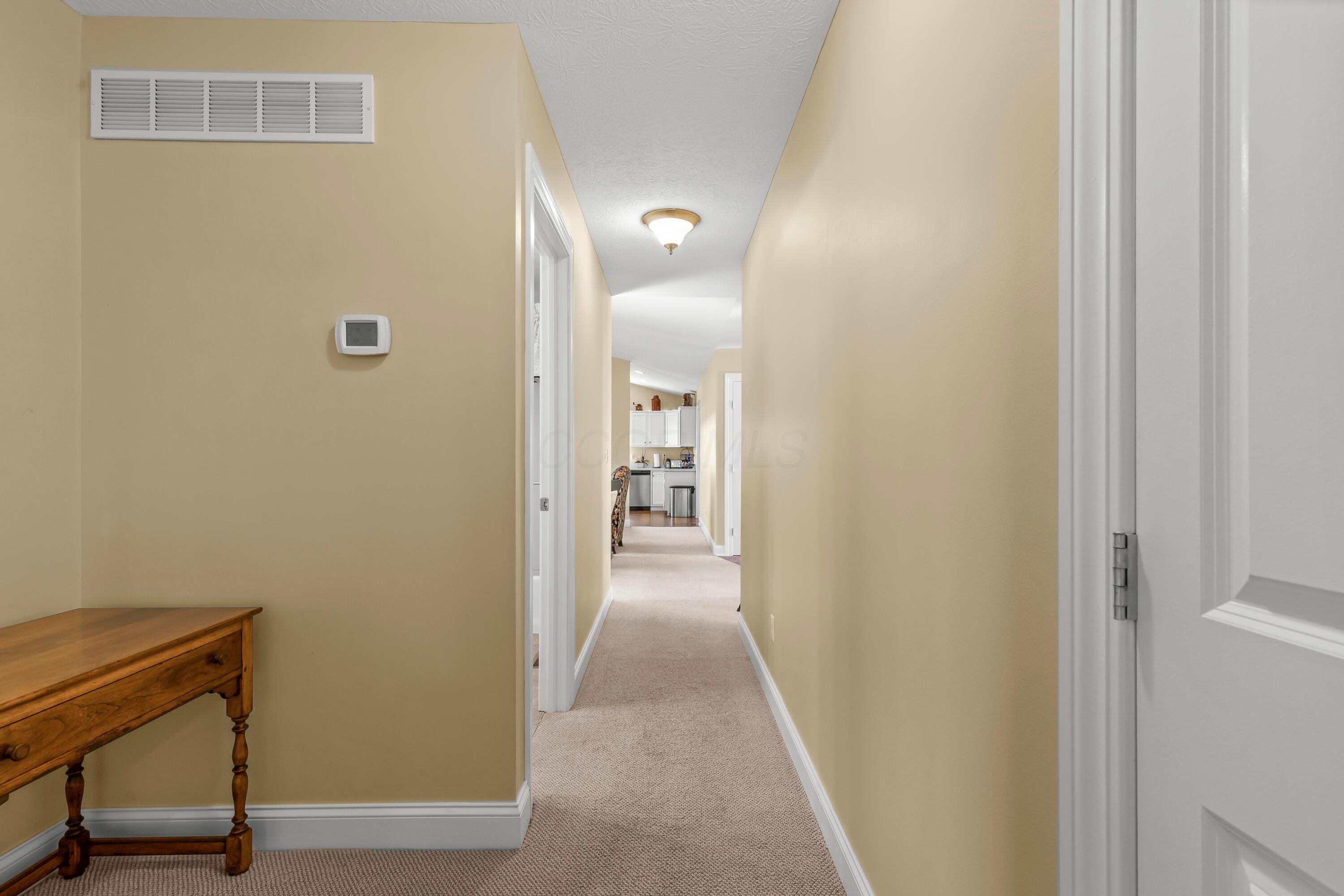 3582 Panhandle Road Delaware, OH 43015 - Photo 7 of 65 • Berber carpet • Vanilla painted walls • Ceiling light • Hall linen closet • Attic access