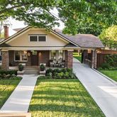a front view of a house with yard and green space