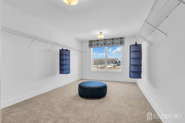 a living room with furniture and a wall painting