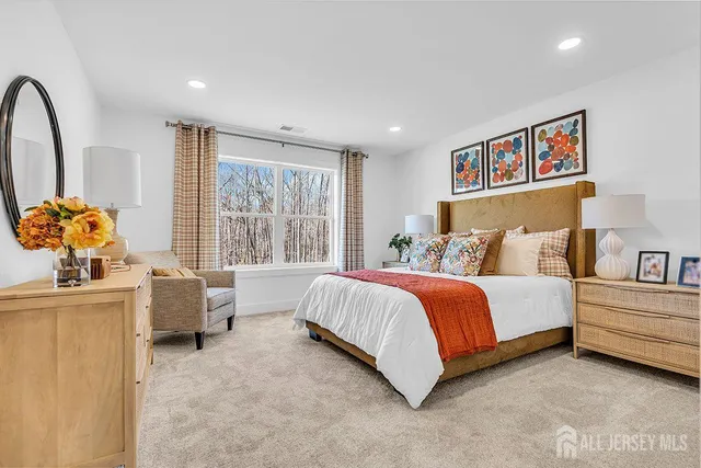 a spacious bedroom with a bed and a couch