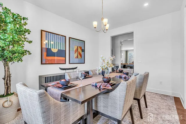 a view of a dining room with furniture wooden floor and a chandelier