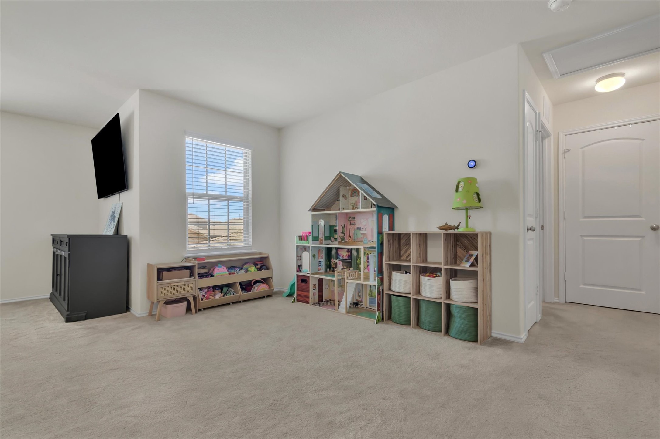 11701 Jackson Falls Way Manor, TX 78653 - Photo 24 of 40 A versatile bonus room offers ample space for recreation and relaxation, complemented by natural light through a large window.