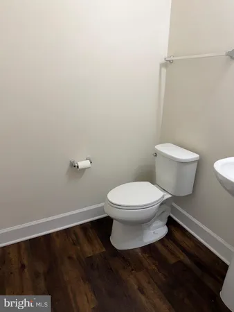 an empty room with wooden floor and a window