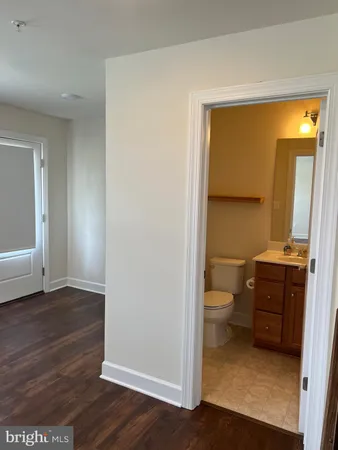 a bathroom with a toilet a sink and vanity