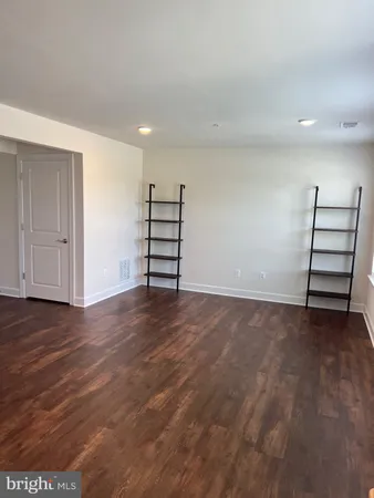 a view of room with wooden floor and closet