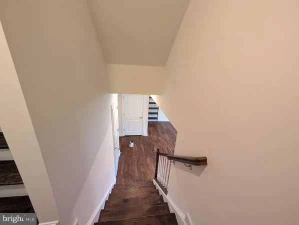 a view of a livingroom with wooden floor and a flat screen tv