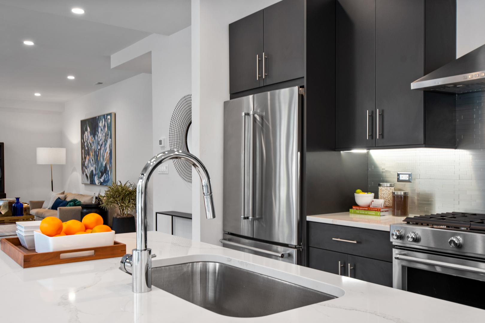 1901 North Halsted Street, Unit 1A Chicago, IL 60614 - Photo 3 of 38 a kitchen with stainless steel appliances granite countertop a sink stove and refrigerator