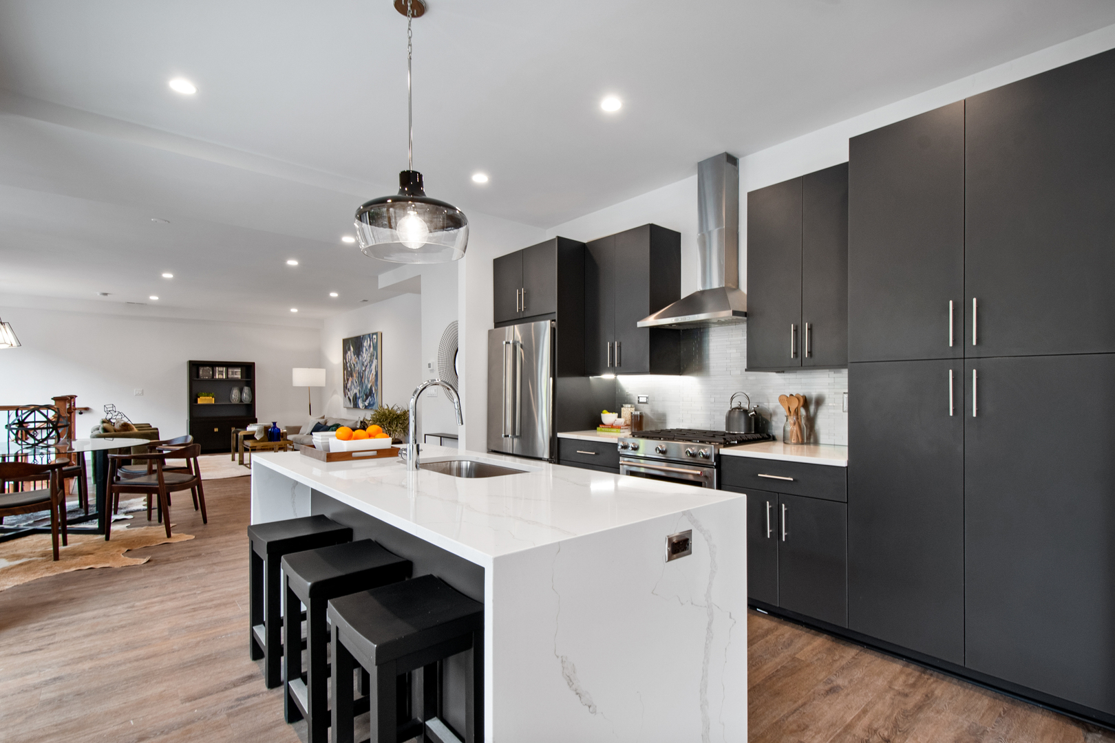 1901 North Halsted Street, Unit 1A Chicago, IL 60614 - Photo 5 of 38 a kitchen with stainless steel appliances a stove sink refrigerator dining table and chairs