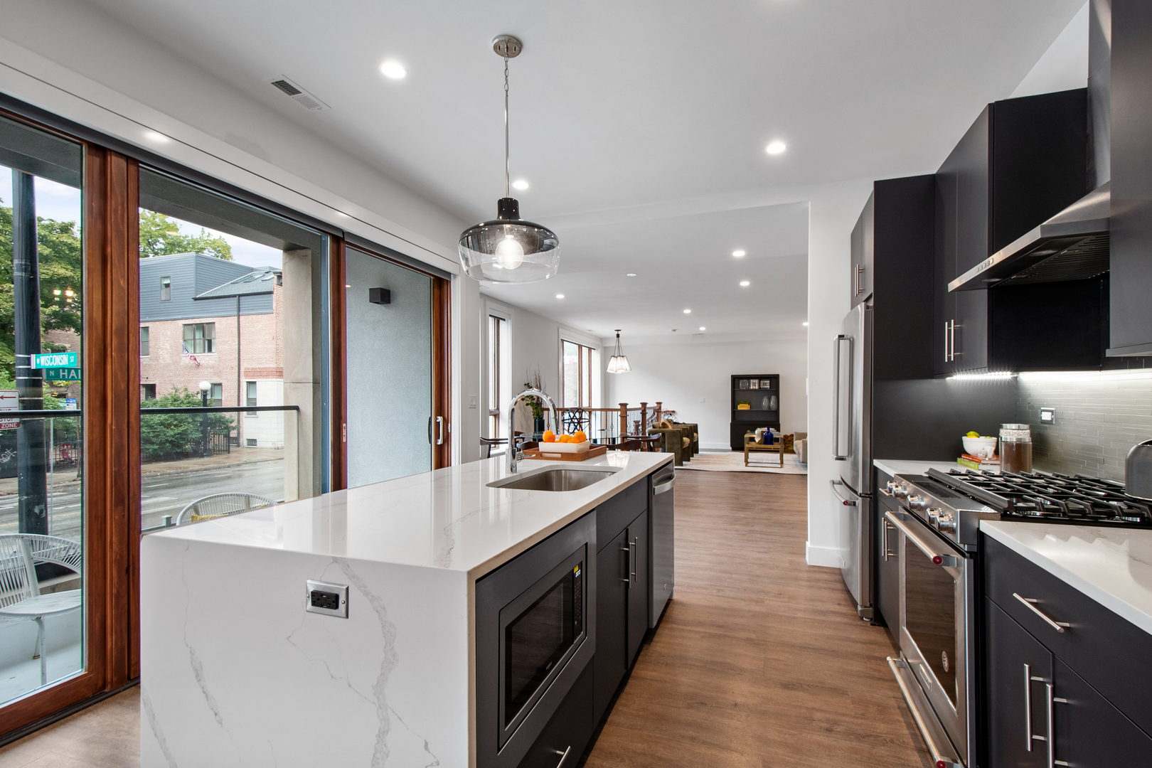 1901 North Halsted Street, Unit 1A Chicago, IL 60614 - Photo 6 of 38 a kitchen with stainless steel appliances granite countertop a sink a stove and a refrigerator