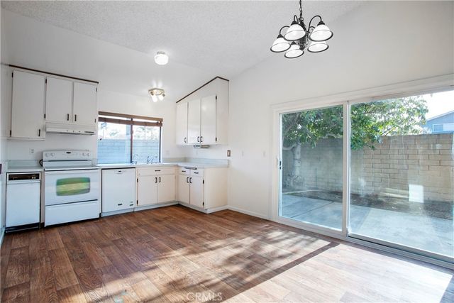 a large white kitchen with a window