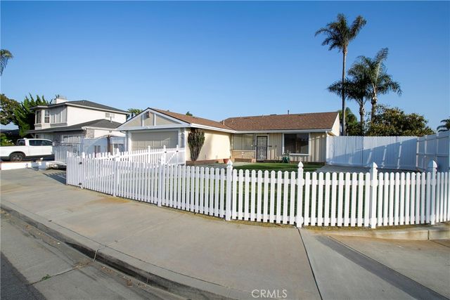 a view of a house with a small yard and a potted plants