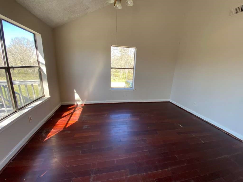 236 Adelaide Drive Cleveland, TX 77327 - Photo 13 of 33 an empty room with wooden floor and windows