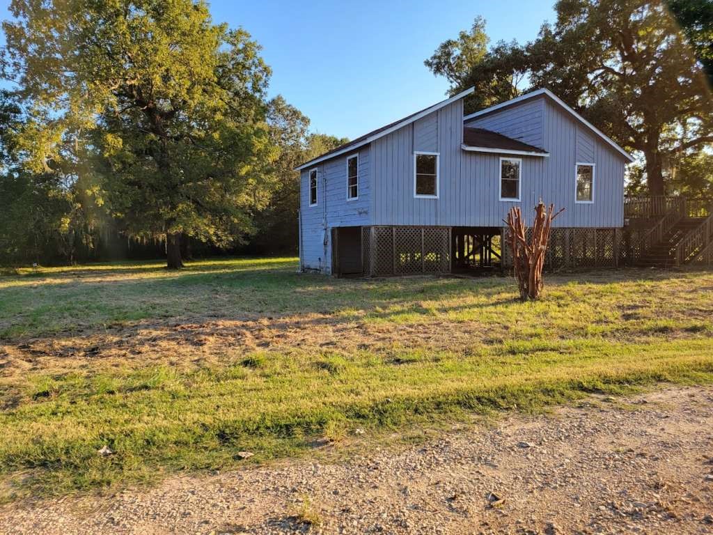 236 Adelaide Drive Cleveland, TX 77327 - Photo 4 of 33 a front view of a house with a yard