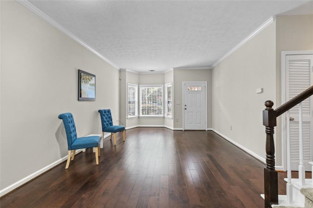 2680 Pine Tree Road Northeast, Unit 5 Atlanta, GA 30324 - Photo 11 of 32 a view of a livingroom with wooden floor and furniture