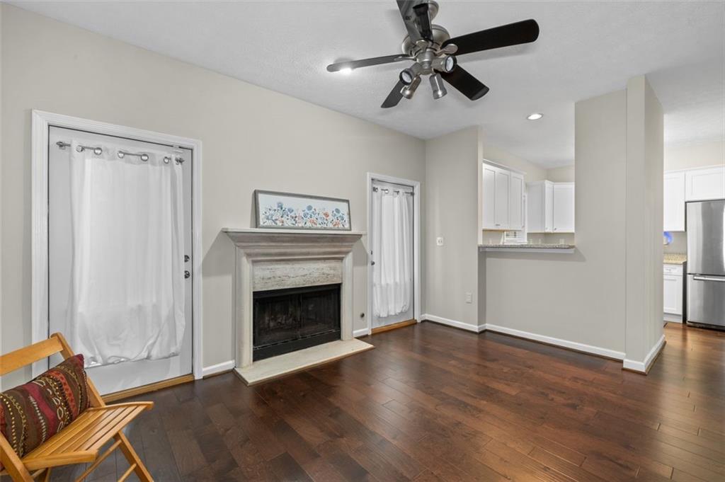 2680 Pine Tree Road Northeast, Unit 5 Atlanta, GA 30324 - Photo 17 of 32 a view of an empty room with wooden floor fireplace and a window