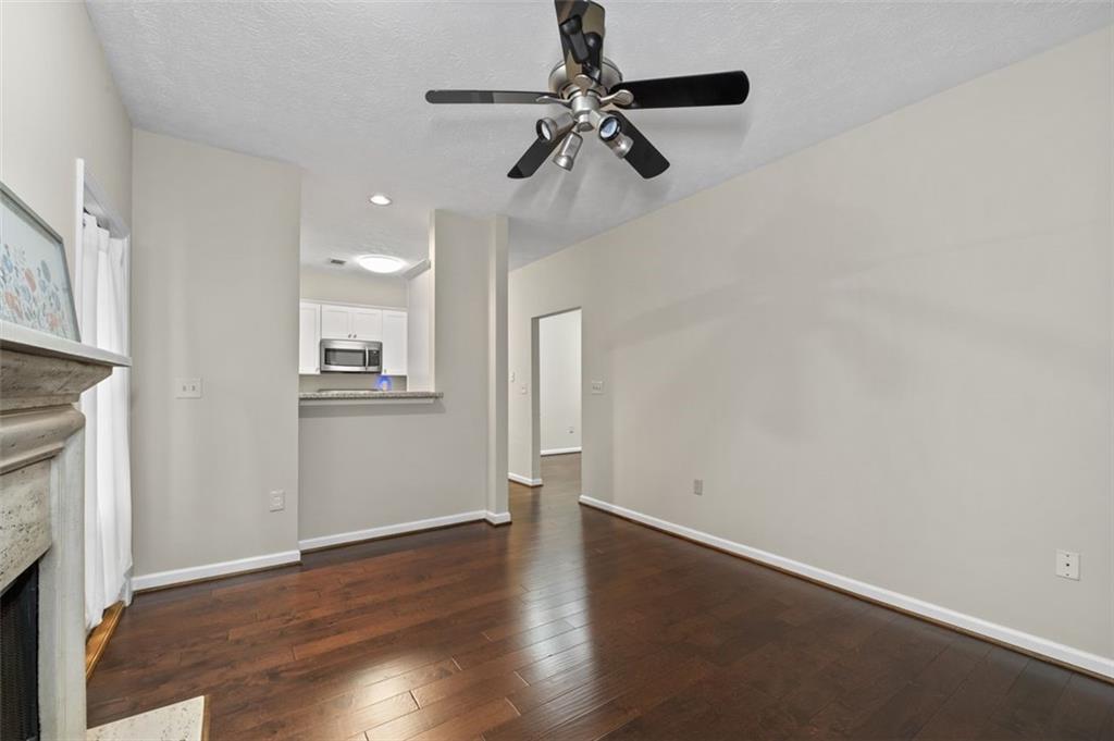 2680 Pine Tree Road Northeast, Unit 5 Atlanta, GA 30324 - Photo 18 of 32 an empty room with wooden floor fireplace and windows