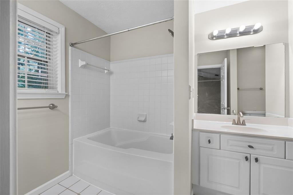 2680 Pine Tree Road Northeast, Unit 5 Atlanta, GA 30324 - Photo 23 of 32 a bathroom with a bathtub and a sink
