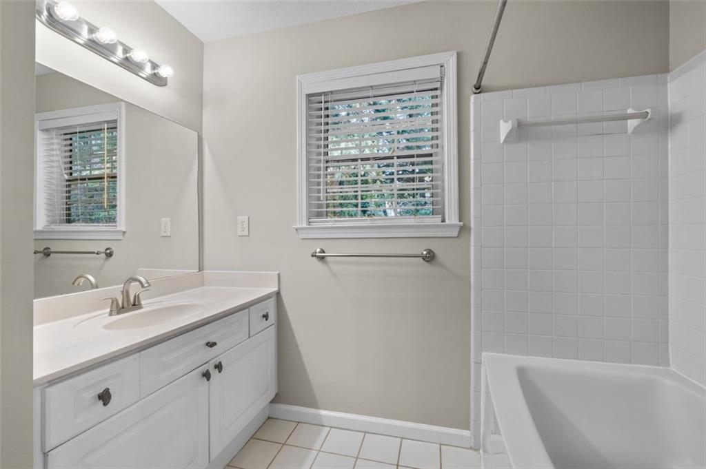 2680 Pine Tree Road Northeast, Unit 5 Atlanta, GA 30324 - Photo 24 of 32 a bathroom with a sink a toilet and shower
