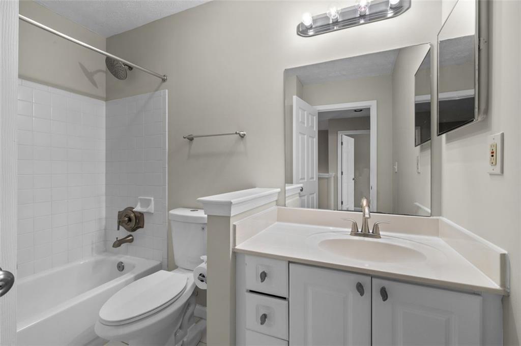 2680 Pine Tree Road Northeast, Unit 5 Atlanta, GA 30324 - Photo 25 of 32 a bathroom with a sink a toilet and shower