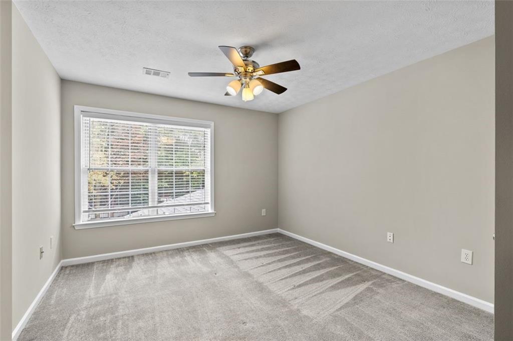 2680 Pine Tree Road Northeast, Unit 5 Atlanta, GA 30324 - Photo 28 of 32 a view of an empty room with a window