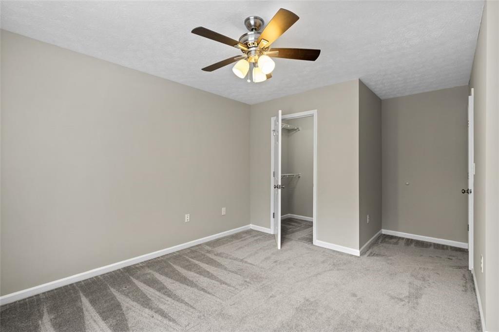 2680 Pine Tree Road Northeast, Unit 5 Atlanta, GA 30324 - Photo 29 of 32 an empty room with closet and a chandelier fan