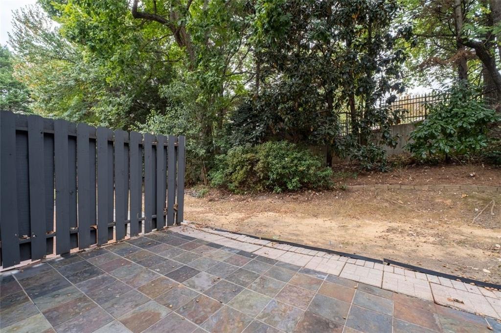 2680 Pine Tree Road Northeast, Unit 5 Atlanta, GA 30324 - Photo 30 of 32 a view of backyard with wooden fence and trees