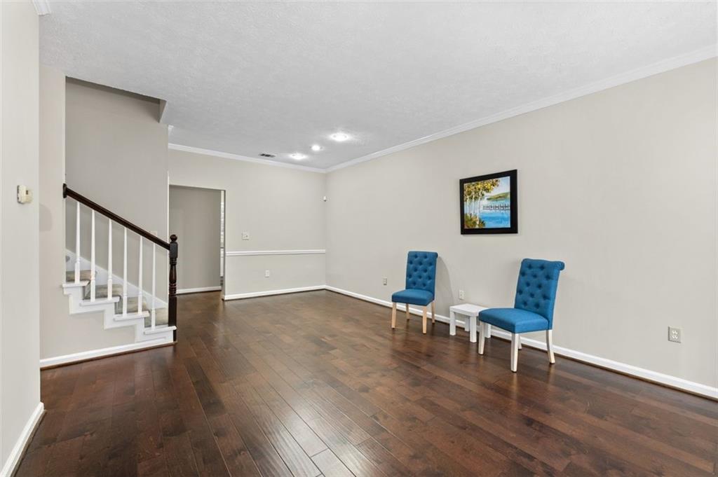 2680 Pine Tree Road Northeast, Unit 5 Atlanta, GA 30324 - Photo 5 of 32 a view of a hallway with wooden floor and a workspace