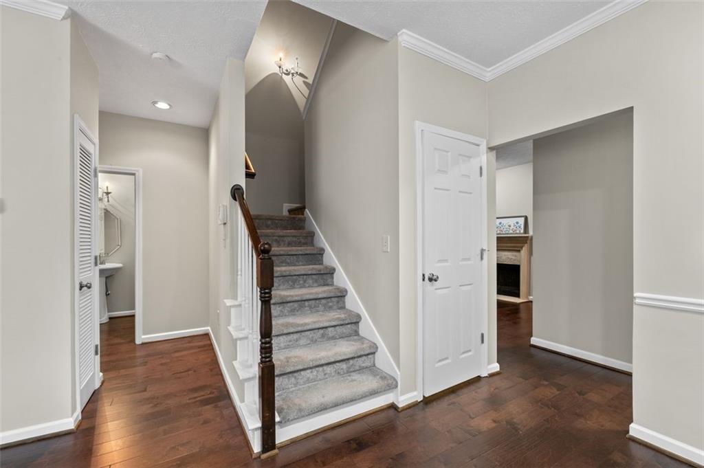 2680 Pine Tree Road Northeast, Unit 5 Atlanta, GA 30324 - Photo 8 of 32 a view of a hallway with wooden floor and entryway