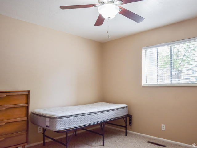 240 East 400 North, Unit 26 Logan, UT 84321 - Photo 8 of 10 Bedroom featuring light colored carpet and a ceiling fan