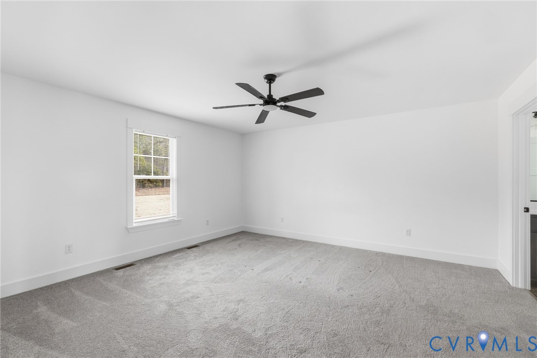 5245 Courtland Road Disputanta, VA 23842 - Photo 13 of 27 an empty room with window and ceiling fan