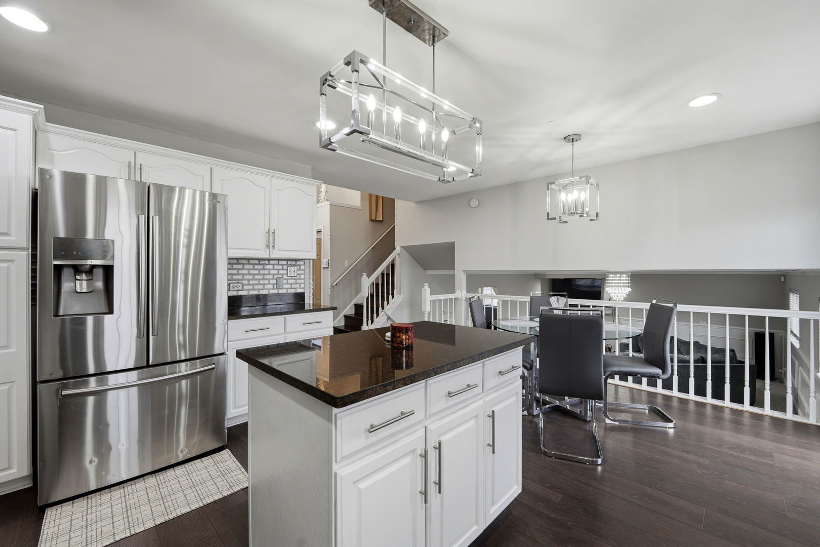 22931 Ridgeway Avenue Richton Park, IL 60471 - Photo 8 of 32 a kitchen with stainless steel appliances granite countertop a refrigerator a stove a sink dishwasher a dining table and chairs with wooden floor