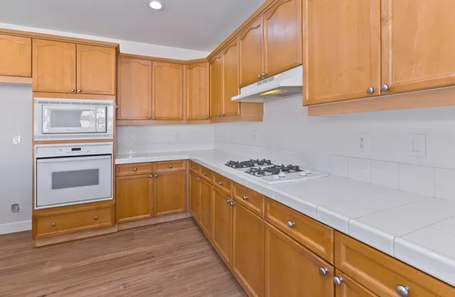 a kitchen with a stove a sink and a microwave