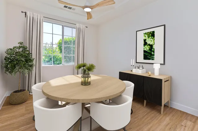 a view of a dining room with furniture window and wooden floor
