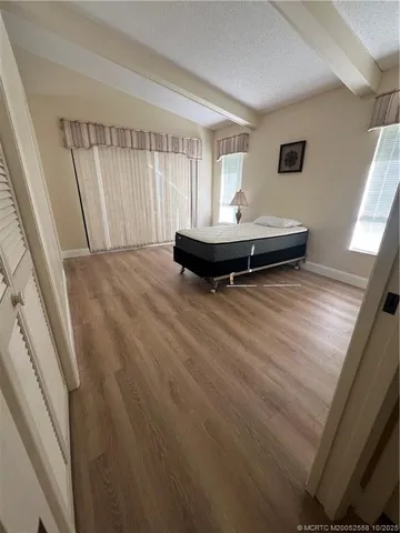 a view of a room with wooden floor and window