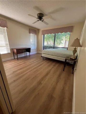 a view of a room with a window and wooden floor