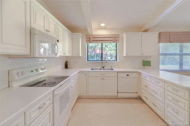 a kitchen with sink cabinets and window