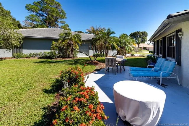 a front view of house with a garden