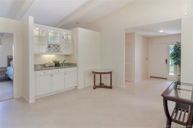 a view of a kitchen with cabinets and wooden floor