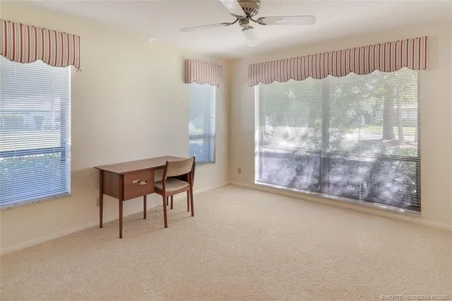 a view of a livingroom with furniture and a window