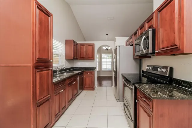 a kitchen with stainless steel appliances granite countertop a stove and a refrigerator