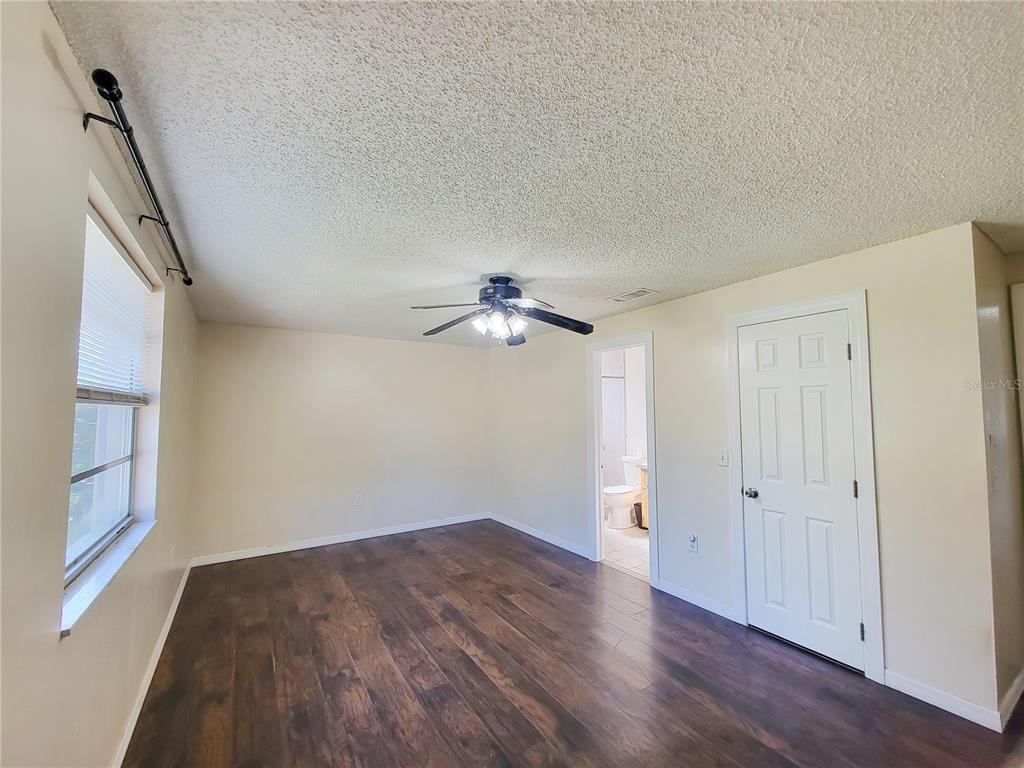 12427 Willow Tree Avenue Hudson, FL 34669 - Photo 18 of 27 wooden floor in an empty room with a window