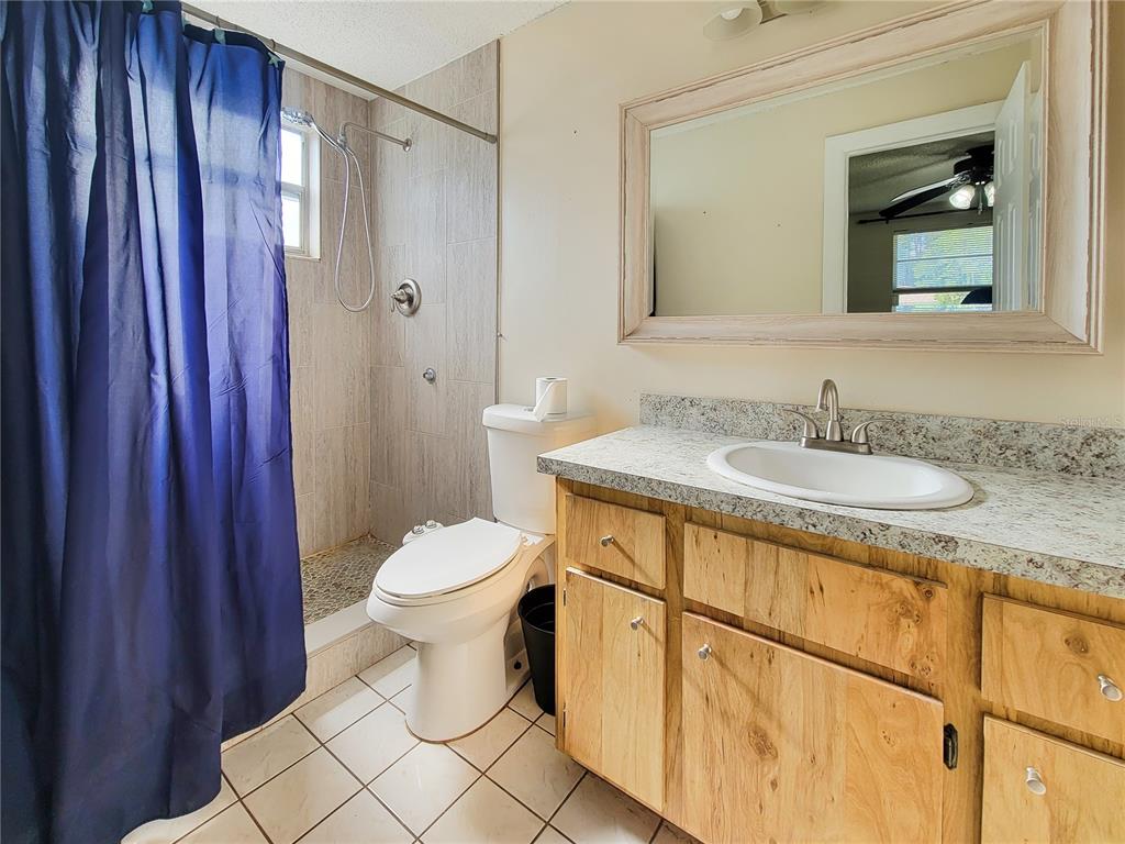 12427 Willow Tree Avenue Hudson, FL 34669 - Photo 20 of 27 a bathroom with a sink a toilet and shower