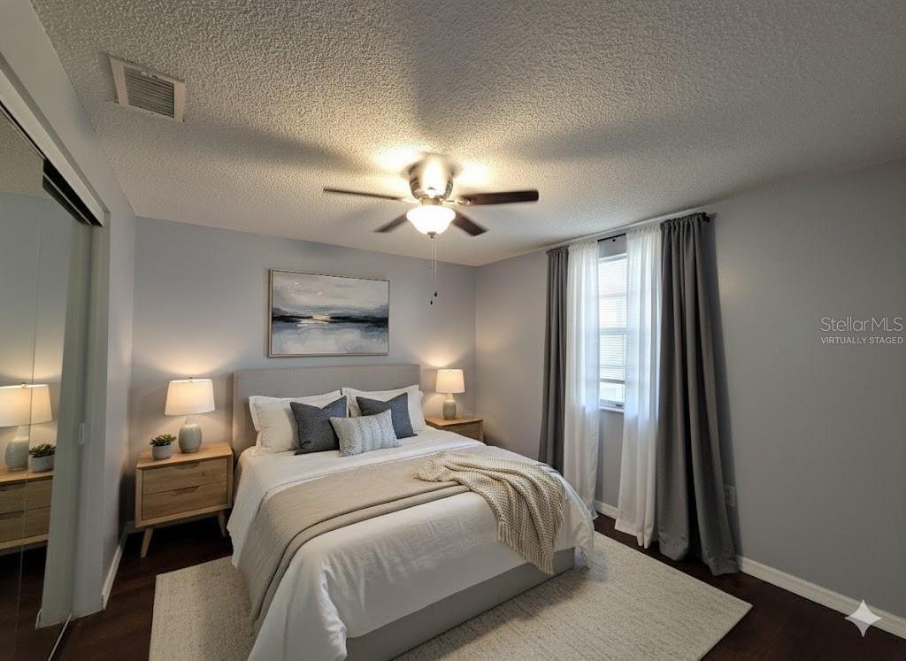 12427 Willow Tree Avenue Hudson, FL 34669 - Photo 21 of 27 a bedroom with a bed and a chandelier